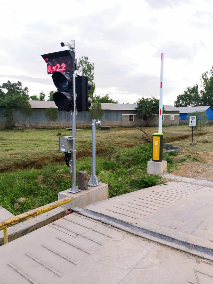 Installed boom barrier and traffic light control at the weighbridge gate. Automated boom barrier and traffic light at cement plant weighbridge gate