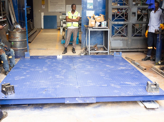 Scalestech technicians calibrate every floor scale against certified test weights before sign-off
